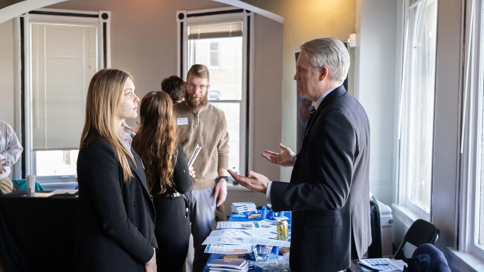 A recruiter speaks with a prospective employee at a federal graduate fellowship career fair.