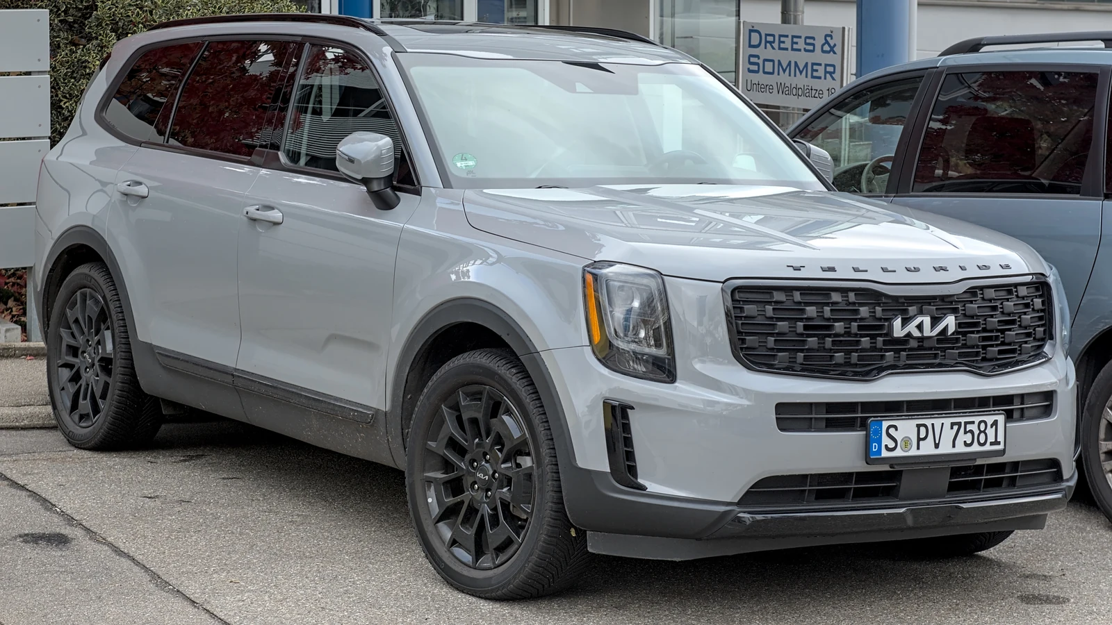 A gray 2022 Kia Telluride is parked outdoors, viewed from the front-left corner.