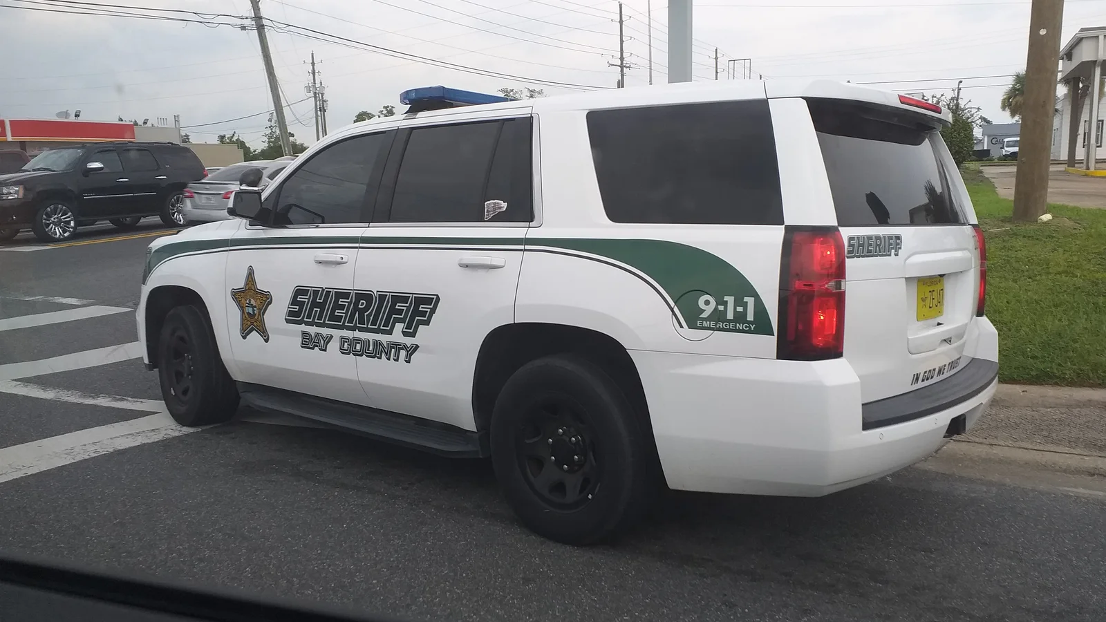 Marked county police patrol vehicle traveling on a divided roadway.