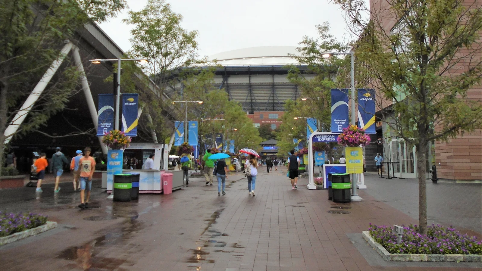 Walkways, trees and crowds lead toward Arthur Ashe Stadium at the U.S. Open grounds.