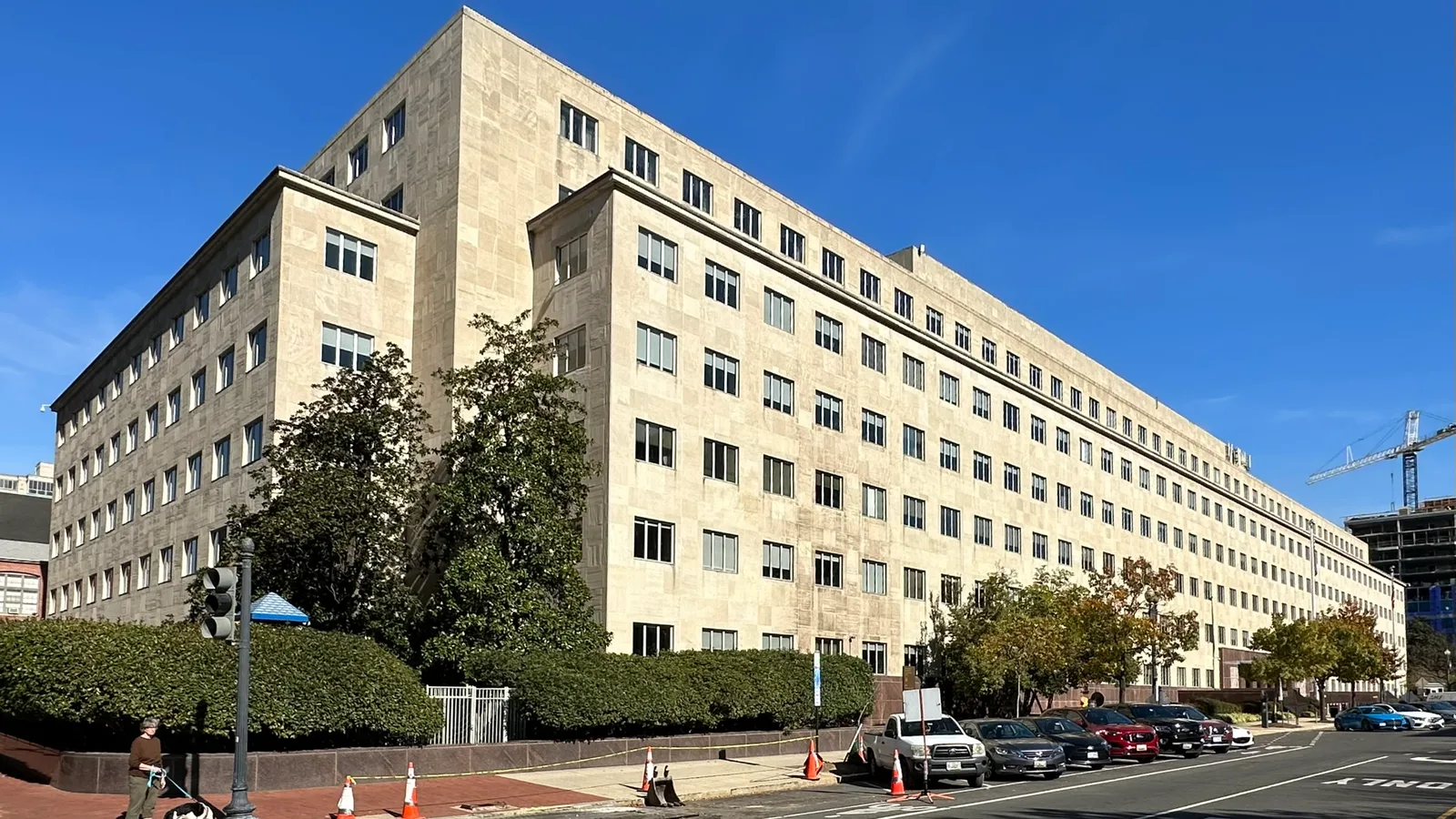 The concrete Government Accountability Office headquarters rises along a Washington street.