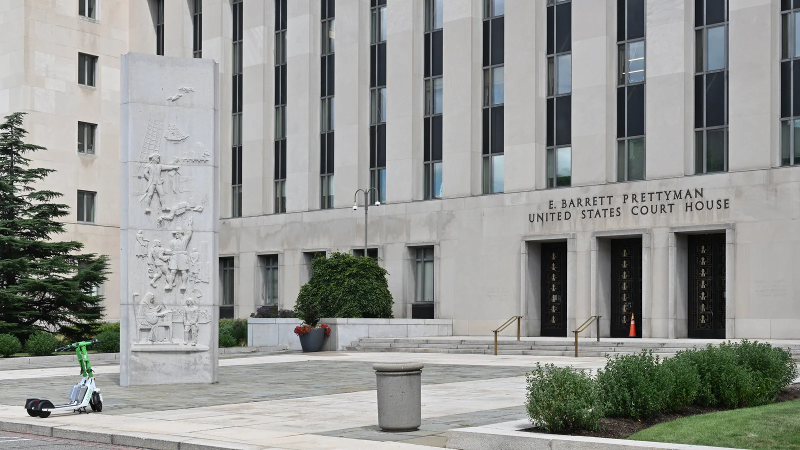 The modernist stone facade and main entrance of the E. Barrett Prettyman U.S. Courthouse.