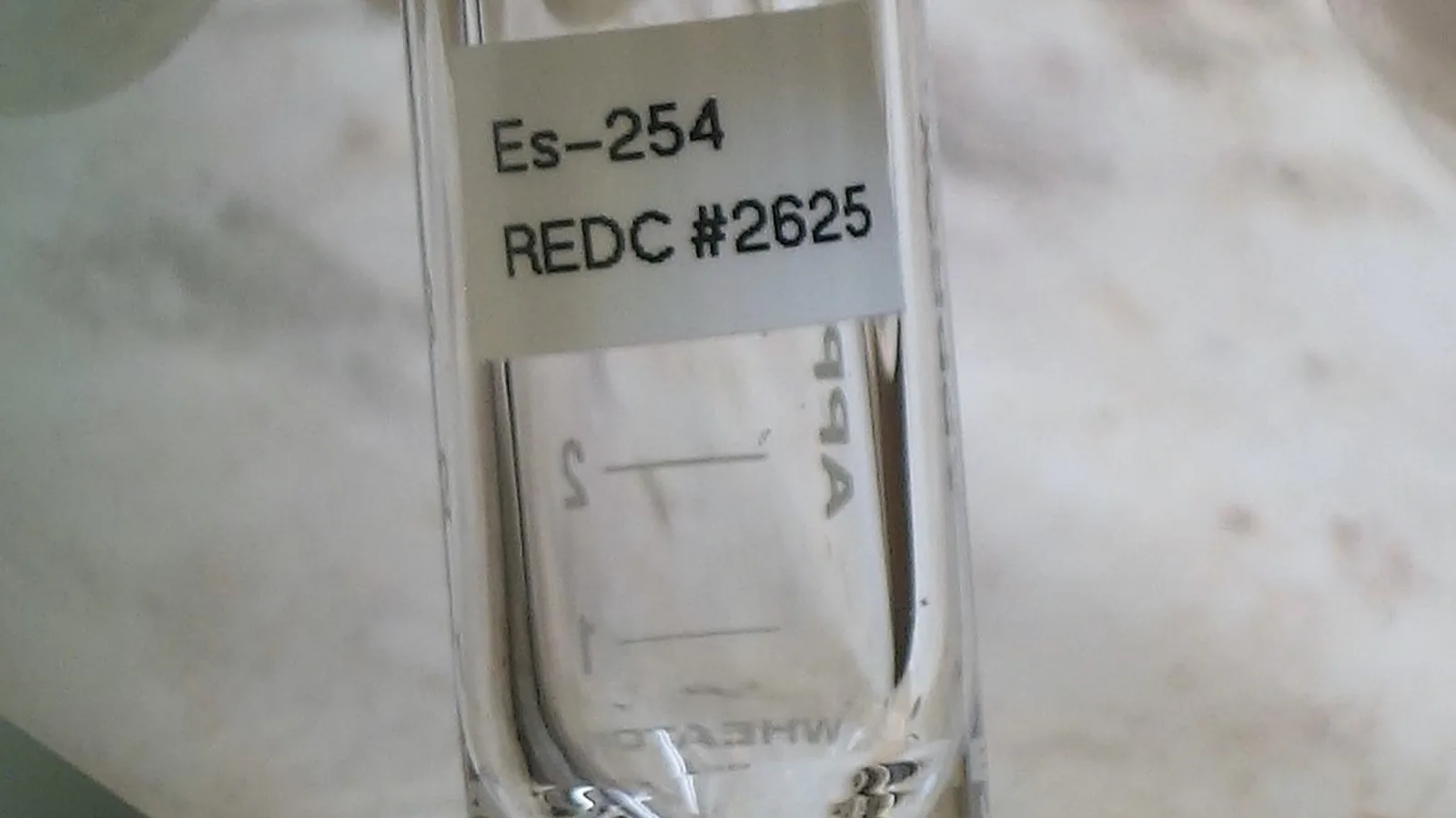 A researcher works with shielded laboratory equipment used in isotope production.
