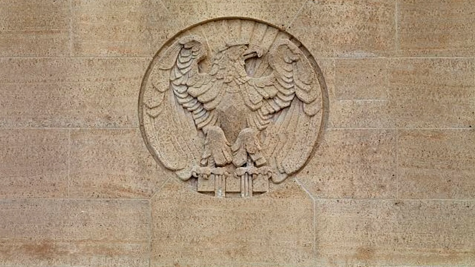 The stone facade and entrance of a United States courthouse fill the frame.